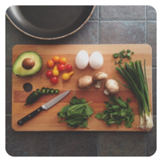 chopping board with vegetables and fruit on it.